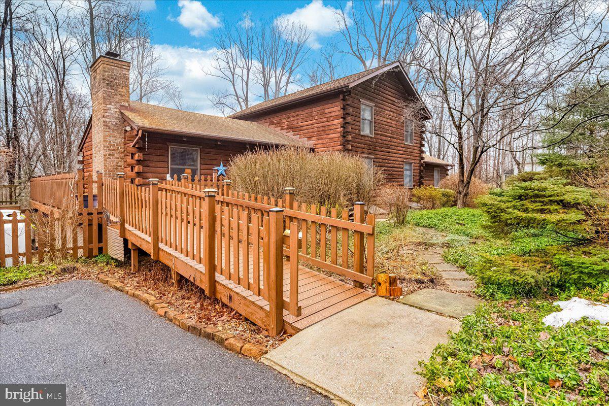 a view of a house with a small yard and wooden fence