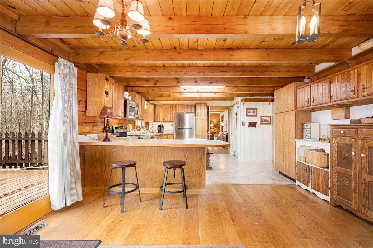 2324 Carrollton Road Westminster, MD 21157 - Photo 12 of 66 a room with stainless steel appliances kitchen island granite countertop a refrigerator and wooden cabinets
