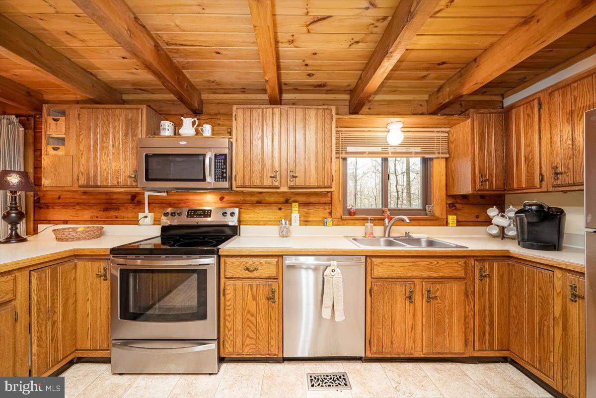2324 Carrollton Road Westminster, MD 21157 - Photo 16 of 66 a kitchen with kitchen island granite countertop a sink cabinets and stainless steel appliances