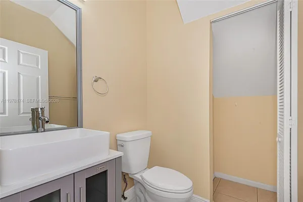 a bathroom with a toilet a sink and mirror