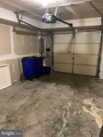 a view of a house with wooden deck stairs and a floor to ceiling window