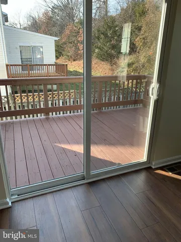 a view of a balcony with wooden floor