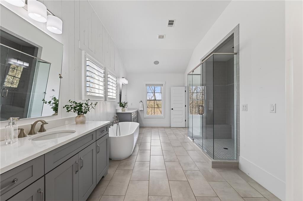554 Gables Run Milton, GA 30004 - Photo 18 of 47 a spacious bathroom with a double vanity sink a mirror and a shower