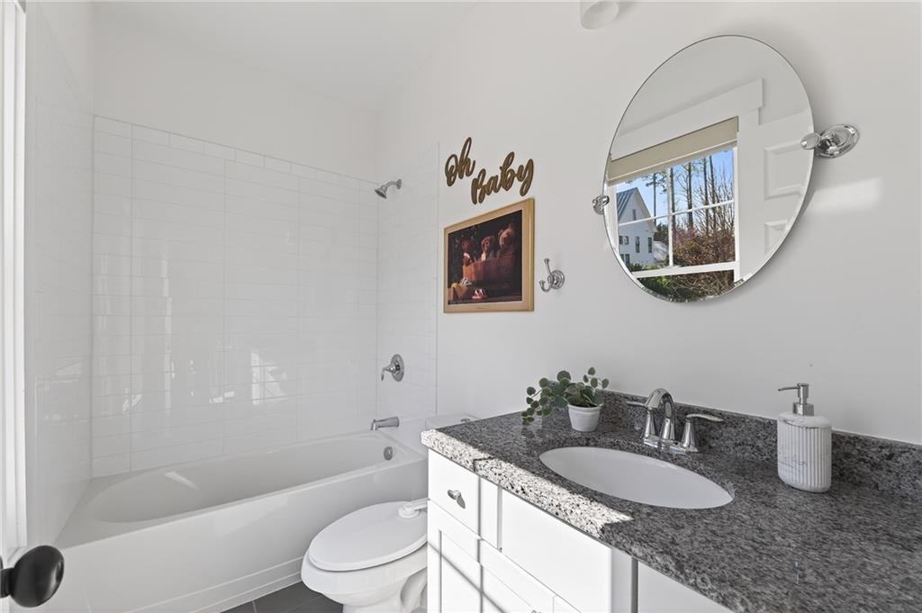 554 Gables Run Milton, GA 30004 - Photo 22 of 47 a bathroom with a granite countertop sink a toilet and a mirror