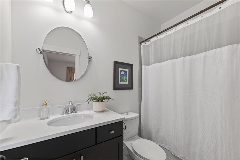 554 Gables Run Milton, GA 30004 - Photo 25 of 47 a bathroom with a toilet sink vanity and mirror