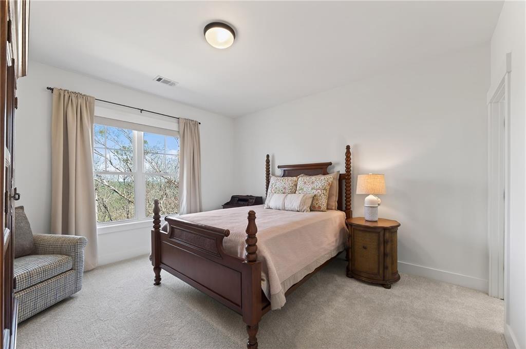 554 Gables Run Milton, GA 30004 - Photo 26 of 47 a bedroom with a bed lamp and a large window