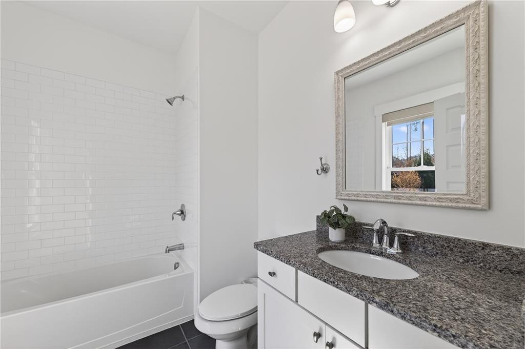 554 Gables Run Milton, GA 30004 - Photo 27 of 47 a bathroom with a granite countertop sink and a mirror