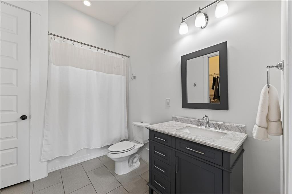 554 Gables Run Milton, GA 30004 - Photo 32 of 47 a bathroom with a granite countertop sink toilet and shower