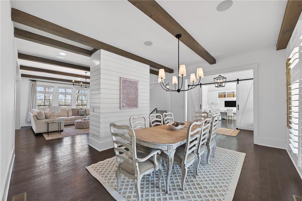 554 Gables Run Milton, GA 30004 - Photo 5 of 47 a dining room with wooden floor a chandelier a glass table and chairs