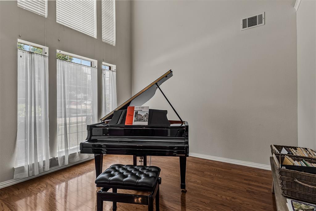 9301 Nottingham Court Rowlett, TX 75088 - Photo 13 of 39 Grand piano positioned within a room featuring wood-finish flooring