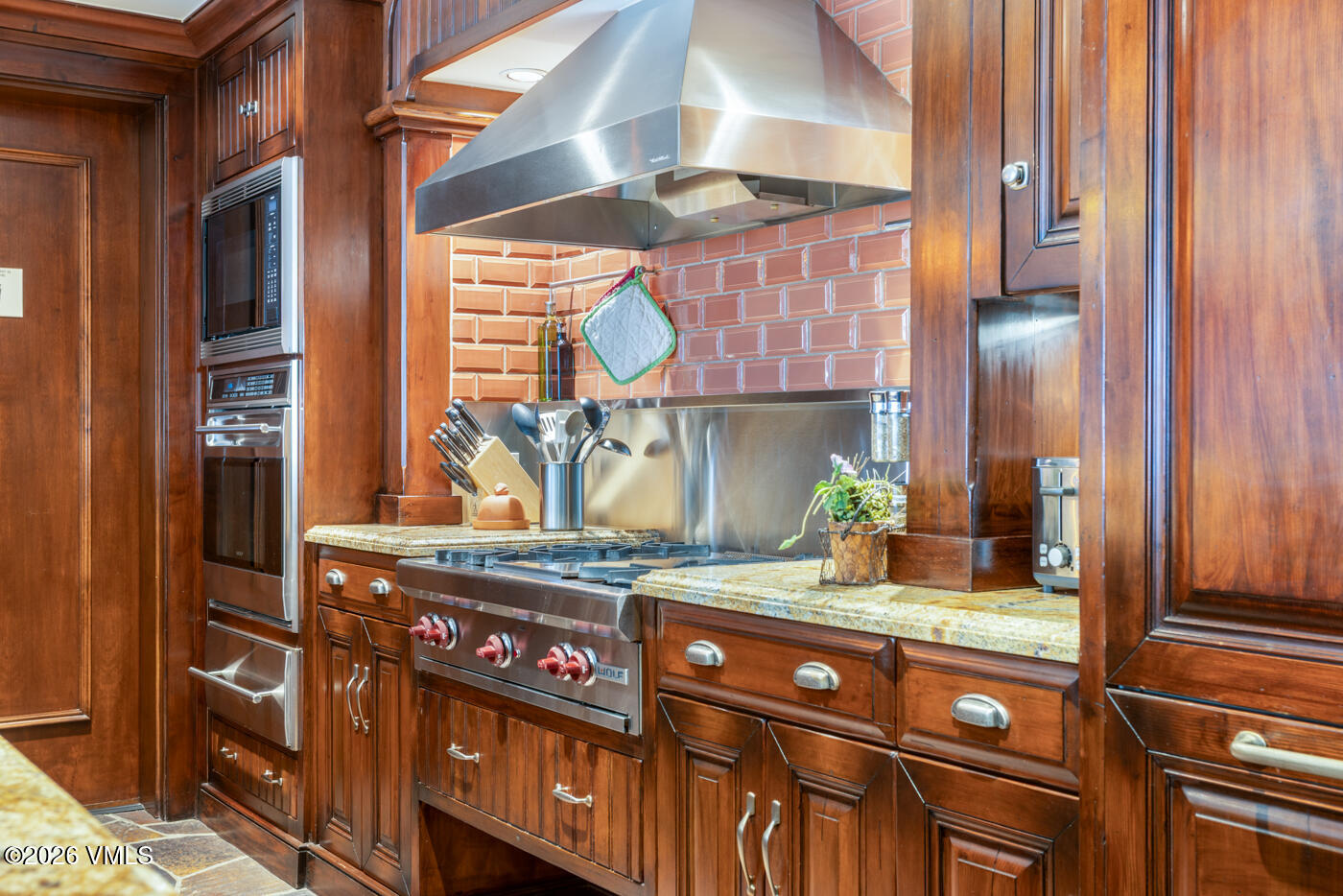 1 Willow Bridge Road, Unit 33 Vail, CO 81657 - Photo 6 of 40 a kitchen with stainless steel appliances granite countertop a sink and a cabinets