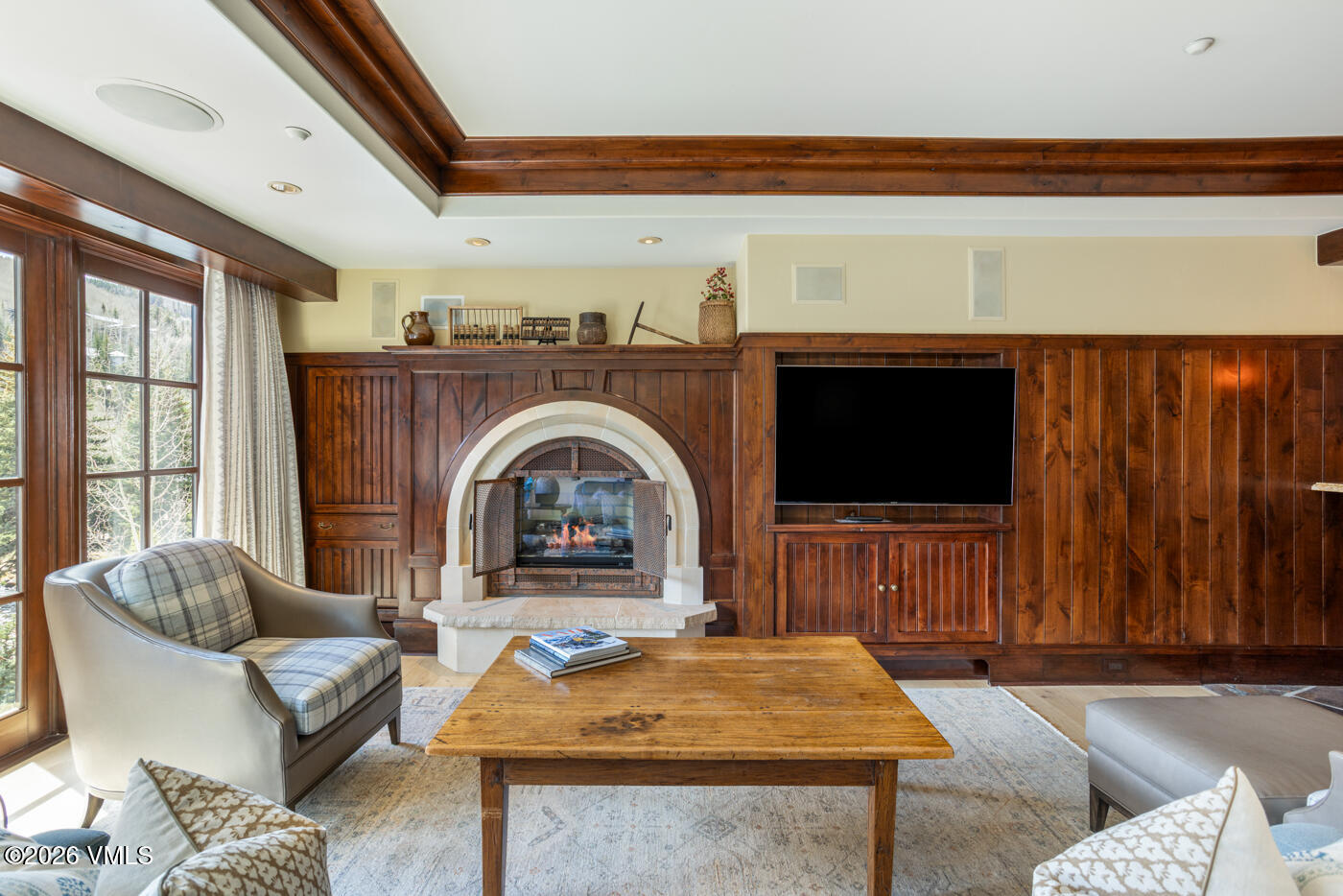 1 Willow Bridge Road, Unit 33 Vail, CO 81657 - Photo 9 of 40 a living room with furniture a flat screen tv and a floor to ceiling window