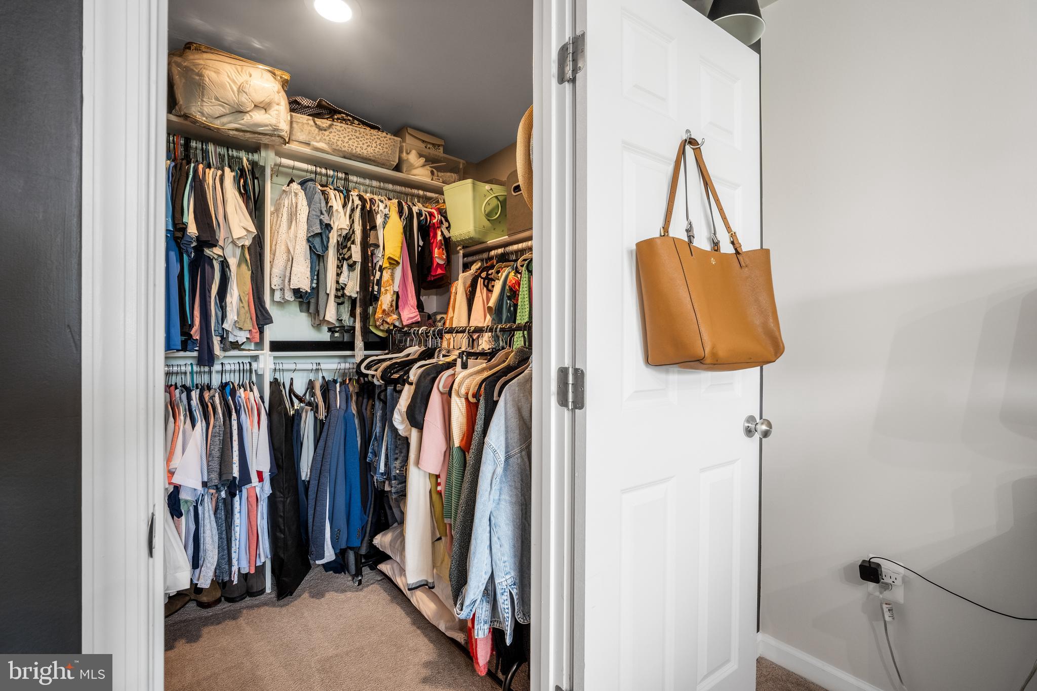 15946 Coolidge Avenue Silver Spring, MD 20906 - Photo 12 of 49 a view of walk in closet with clothes and shoes