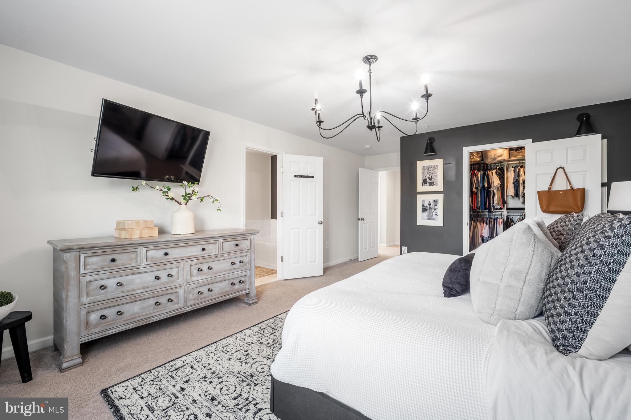 15946 Coolidge Avenue Silver Spring, MD 20906 - Photo 13 of 49 a bedroom with a bed a flat screen tv and dresser