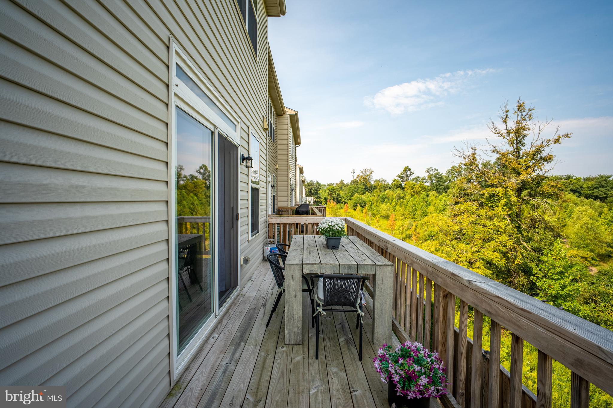 15946 Coolidge Avenue Silver Spring, MD 20906 - Photo 22 of 49 a balcony with wooden floor and outdoor seating