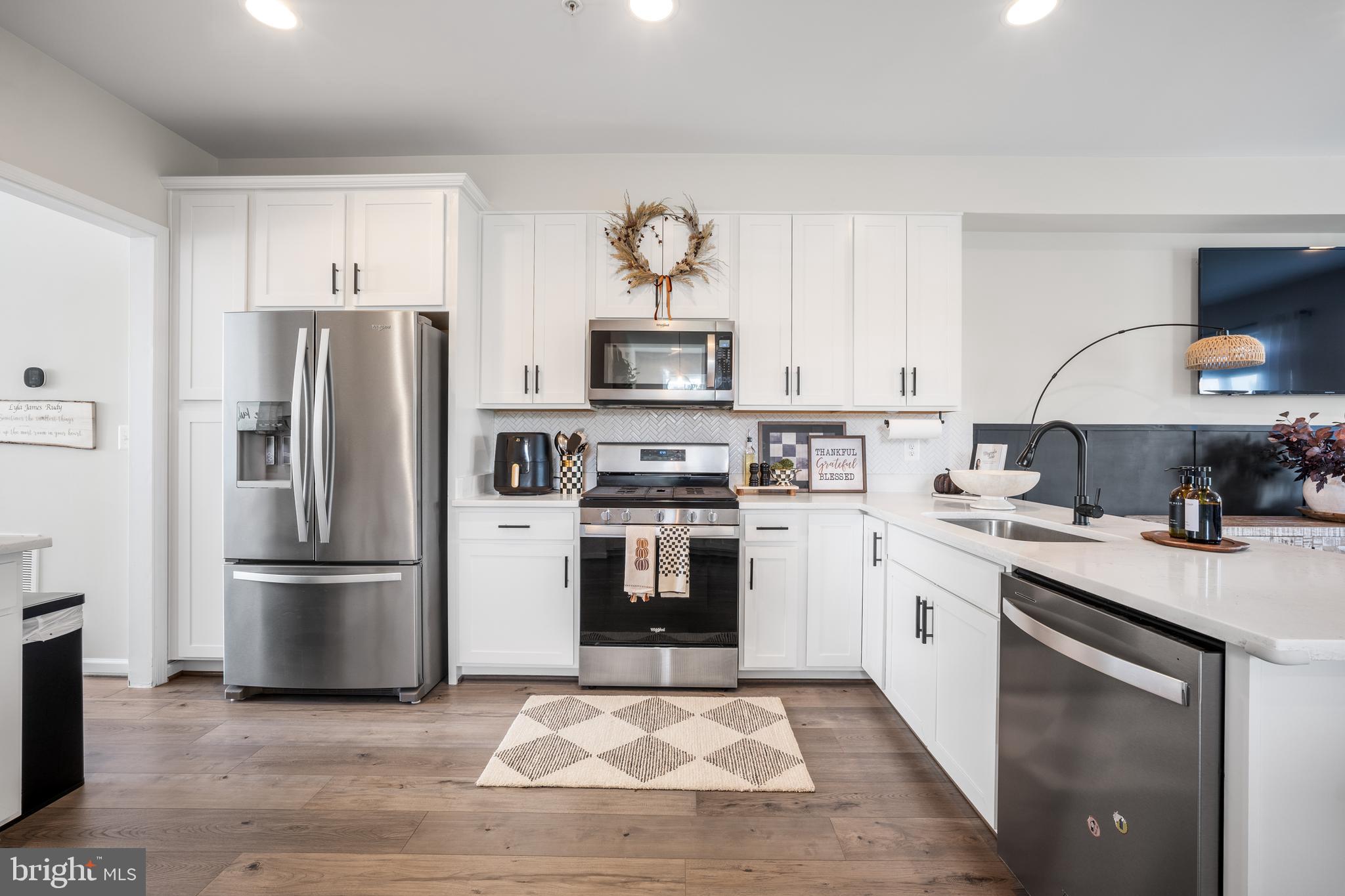 15946 Coolidge Avenue Silver Spring, MD 20906 - Photo 31 of 49 a kitchen with stainless steel appliances granite countertop a stove a refrigerator and a stove top oven