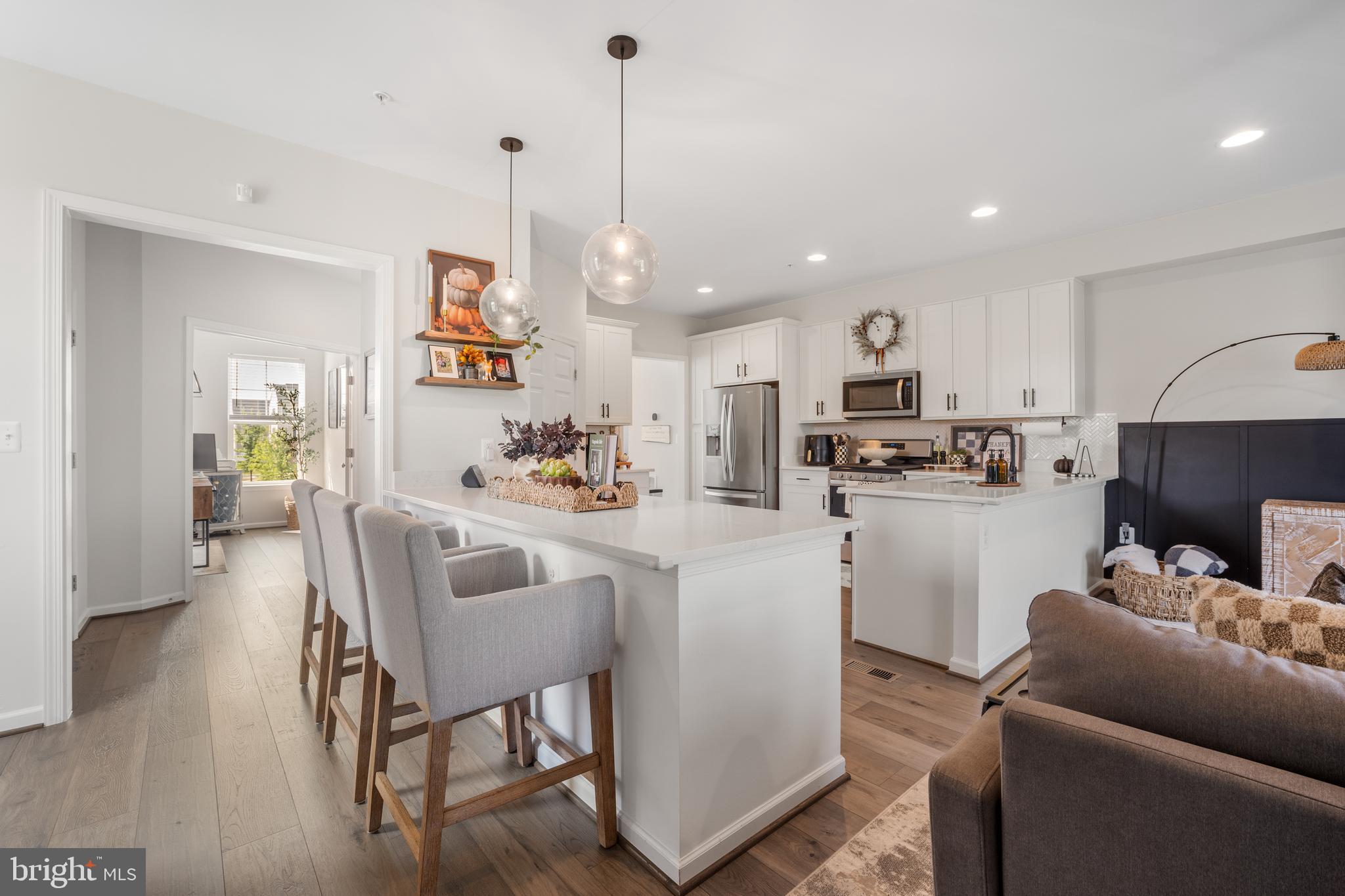 15946 Coolidge Avenue Silver Spring, MD 20906 - Photo 33 of 49 a view of kitchen with kitchen island stainless steel appliances refrigerator stove dining table and chairs