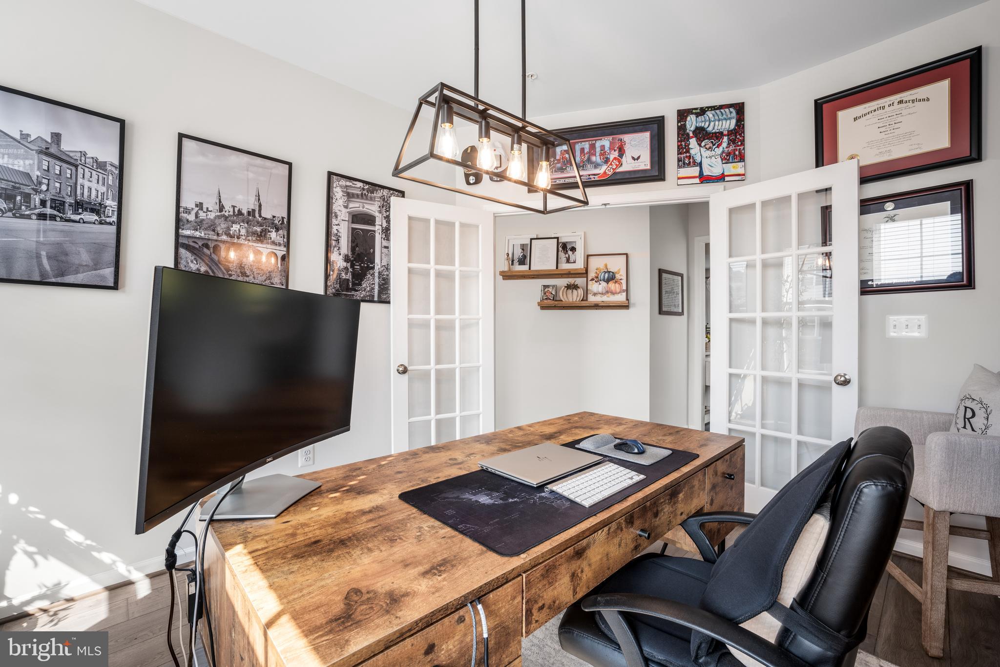 15946 Coolidge Avenue Silver Spring, MD 20906 - Photo 38 of 49 a living room with computer on a table and a flat screen tv
