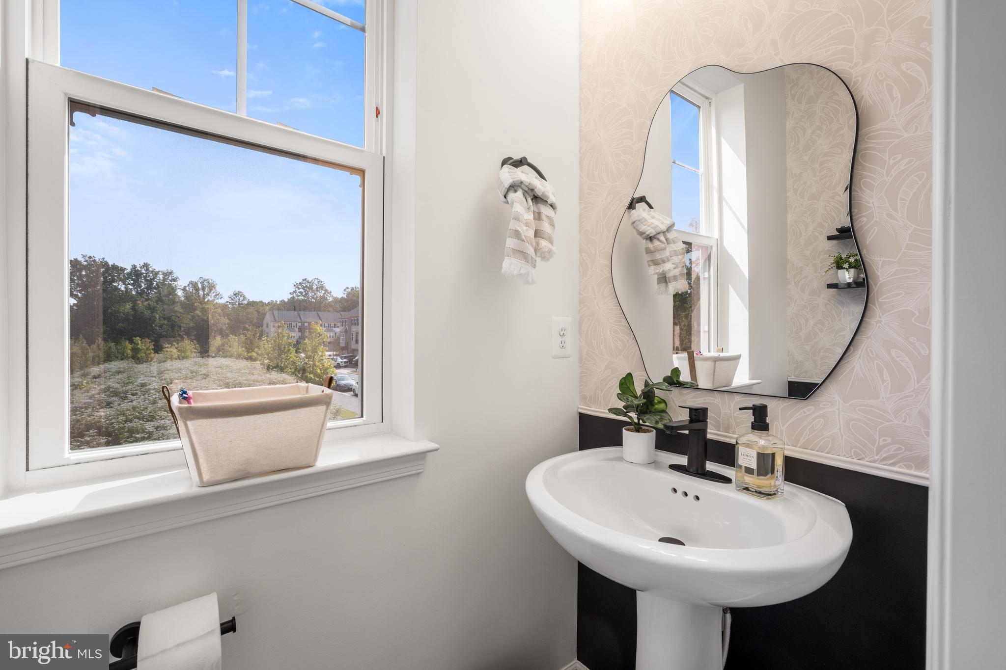 15946 Coolidge Avenue Silver Spring, MD 20906 - Photo 40 of 49 a bathroom with a sink and a mirror