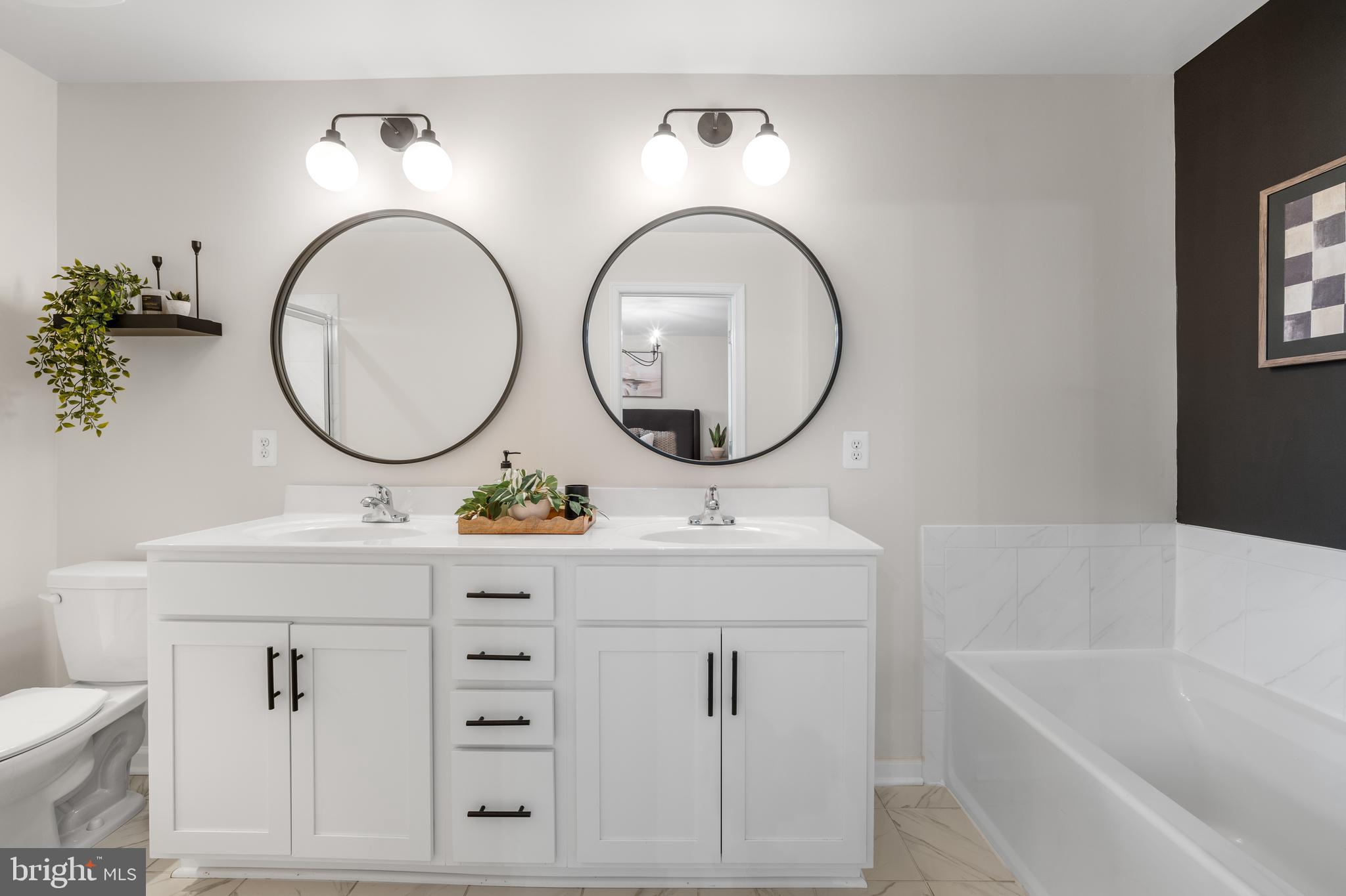15946 Coolidge Avenue Silver Spring, MD 20906 - Photo 10 of 49 a bathroom with a sink a mirror a vanity and a toilet
