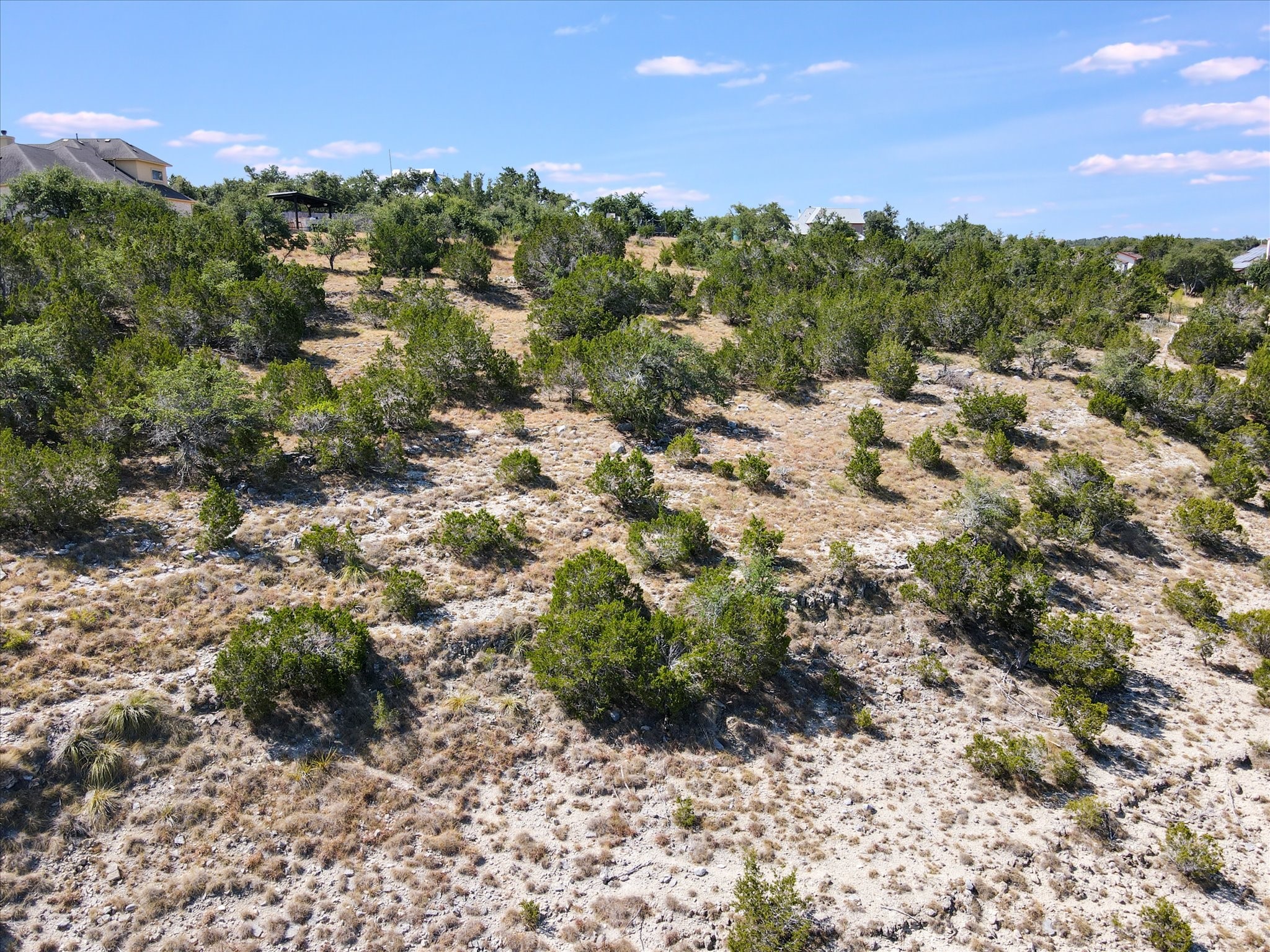 Native trees and limestone terrain give the property its distinctly Central Texas character and provide a natural starting point for a custom homesite.