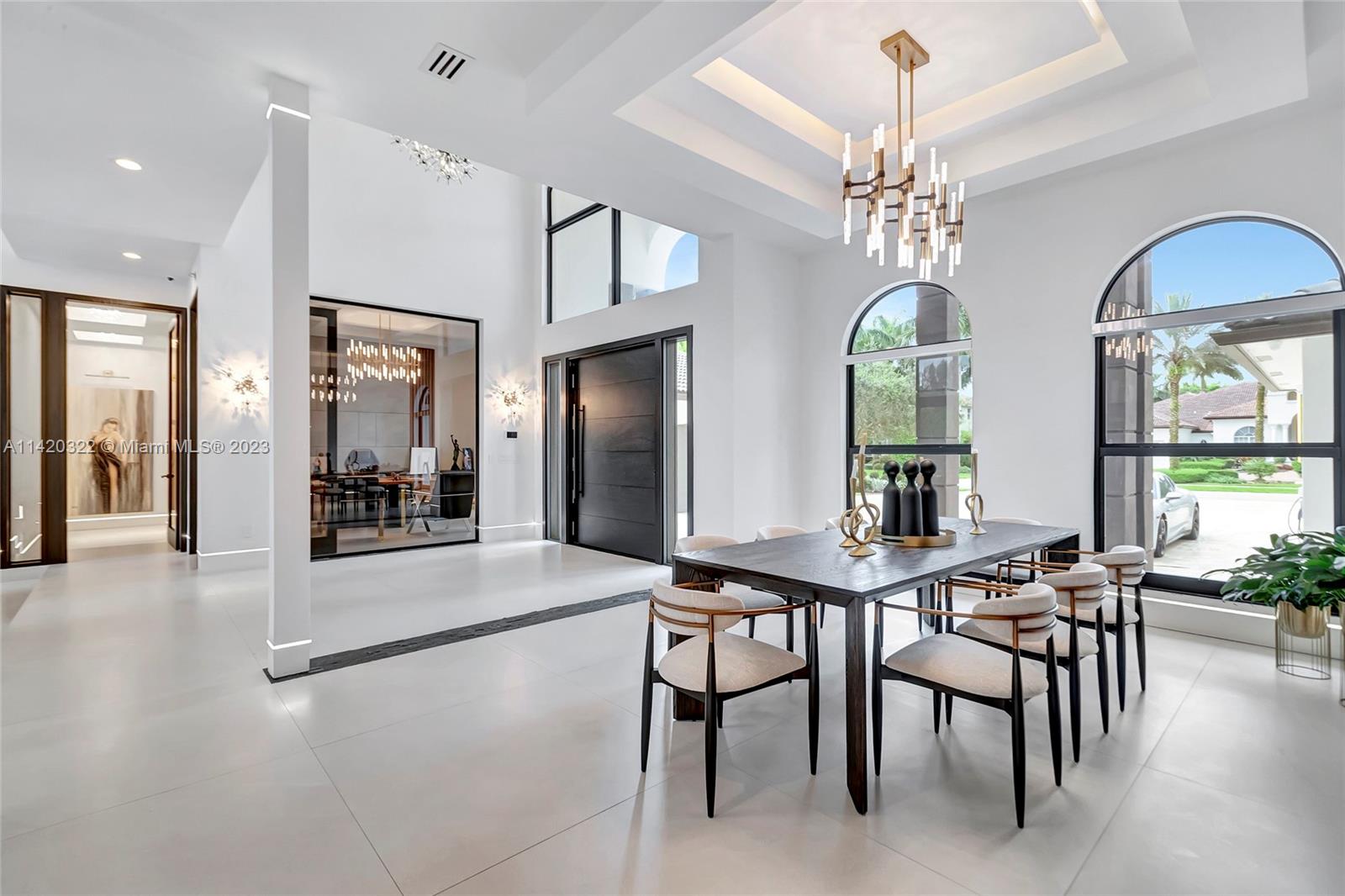 12887 Equestrian Trail Davie, FL 33330 - Photo 15 of 92 a view of a dining room with furniture and a chandelier