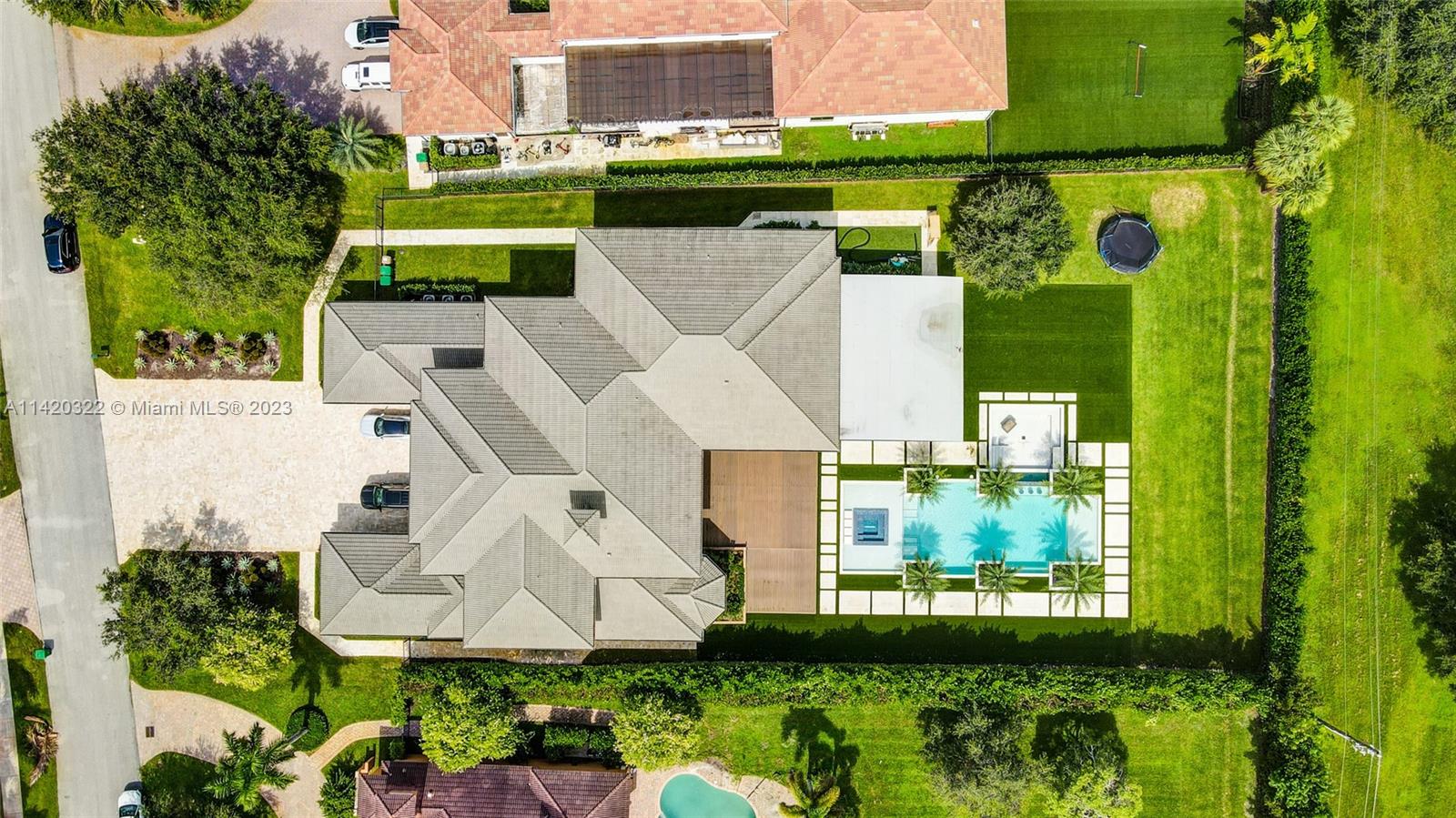 12887 Equestrian Trail Davie, FL 33330 - Photo 2 of 92 an aerial view of a house with a garden and lake view