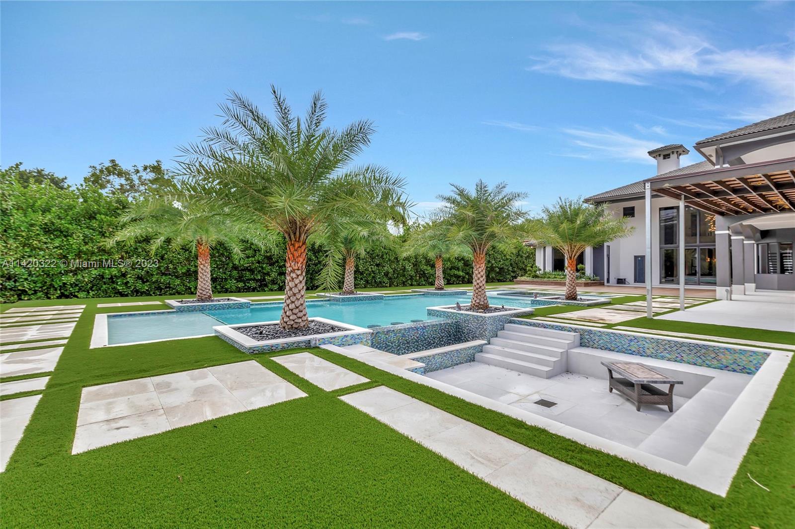 12887 Equestrian Trail Davie, FL 33330 - Photo 45 of 92 a view of swimming pool with seating area and trees in the background