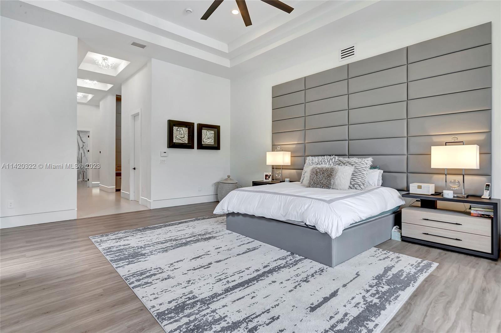12887 Equestrian Trail Davie, FL 33330 - Photo 50 of 92 a bedroom with a large bed and a chandelier
