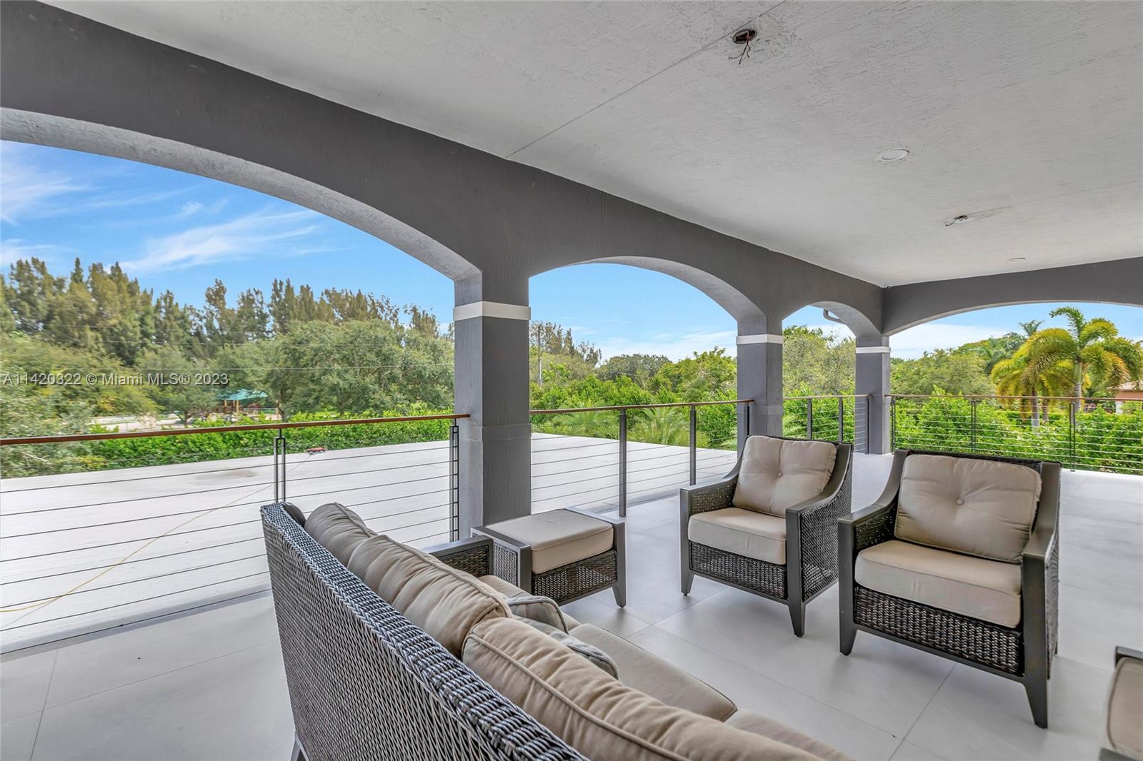 12887 Equestrian Trail Davie, FL 33330 - Photo 64 of 92 a outdoor living space with furniture and garden view