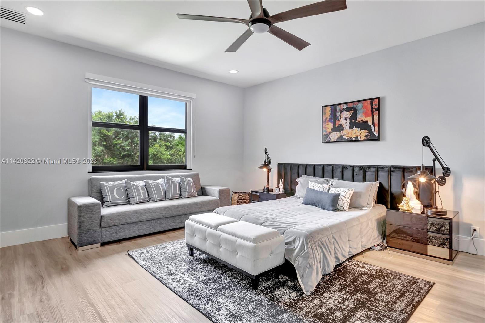 12887 Equestrian Trail Davie, FL 33330 - Photo 67 of 92 a bedroom with a large bed and a couch