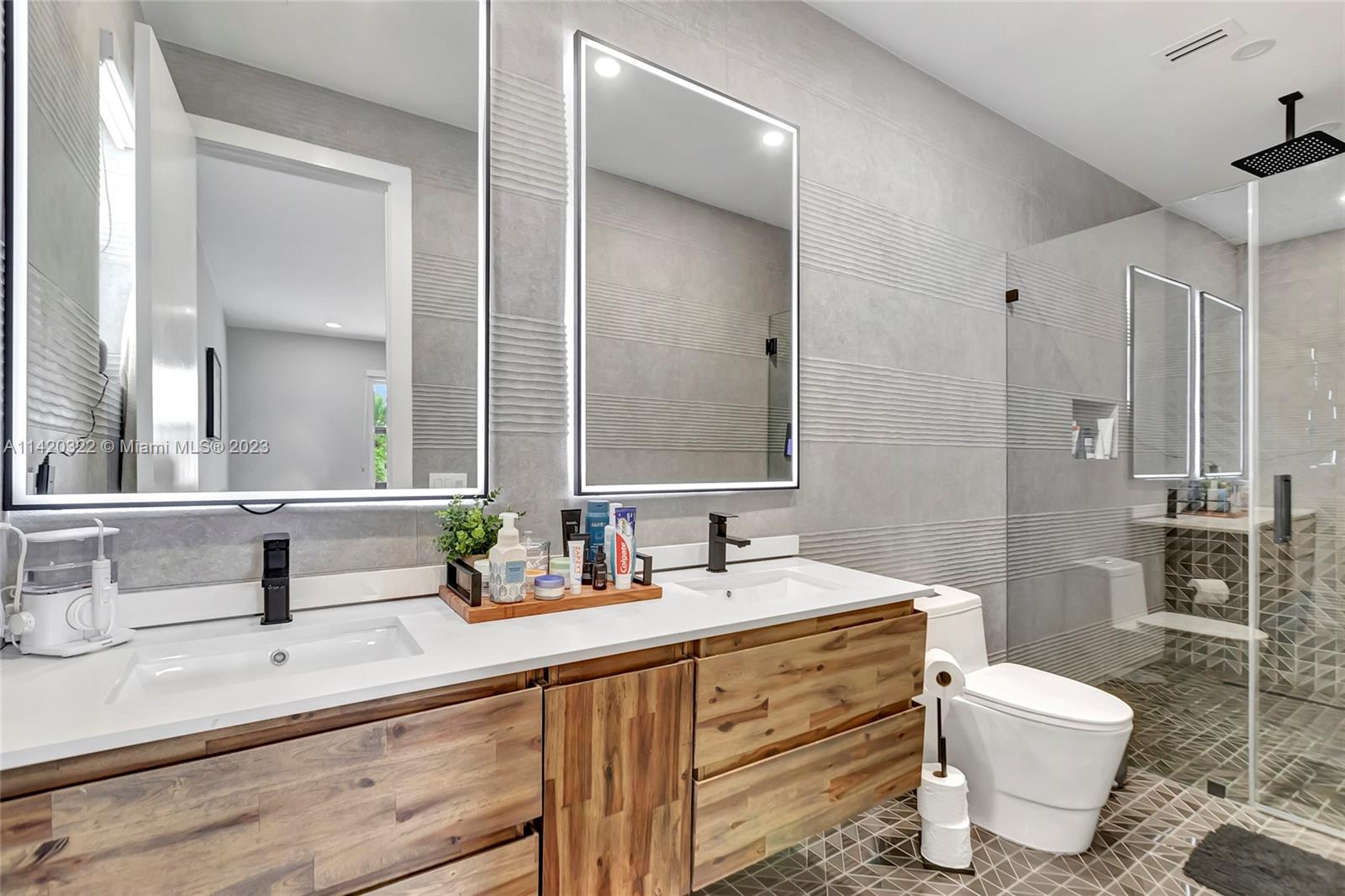 12887 Equestrian Trail Davie, FL 33330 - Photo 68 of 92 a bathroom with a double vanity sink mirror and toilet