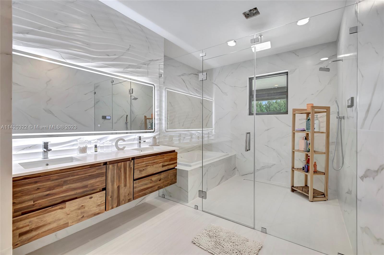 12887 Equestrian Trail Davie, FL 33330 - Photo 71 of 92 a bathroom with a double vanity sink mirror and shower