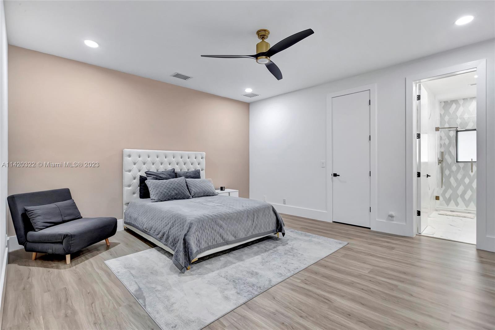 12887 Equestrian Trail Davie, FL 33330 - Photo 77 of 92 a spacious bedroom with a bed and a couch
