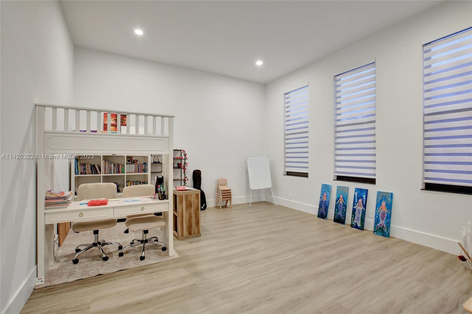 12887 Equestrian Trail Davie, FL 33330 - Photo 79 of 92 a bedroom with furniture and a book shelf