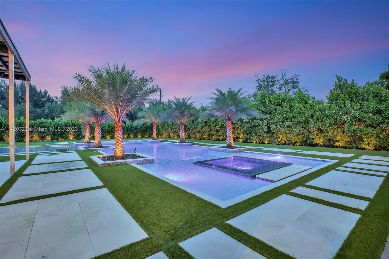 12887 Equestrian Trail Davie, FL 33330 - Photo 83 of 92 a view of a tennis ground with large trees