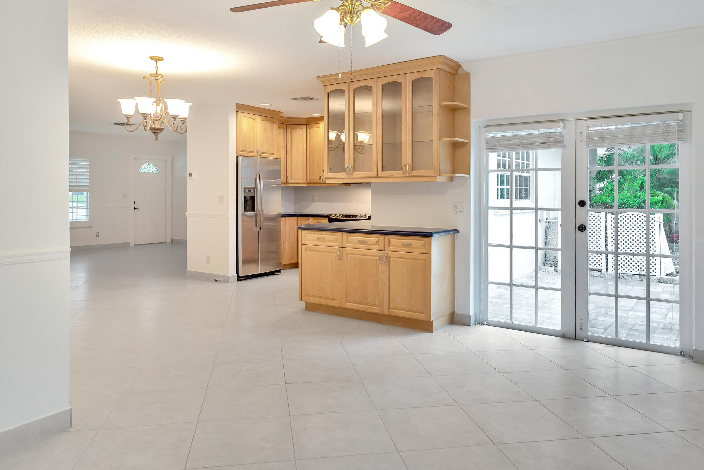 474 Northwest 11th Street Boca Raton, FL 33432 - Photo 18 of 61 a view of a kitchen with refrigerator and a chandelier fan