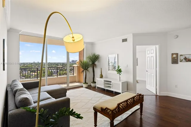 a living room with furniture a table and a potted plant