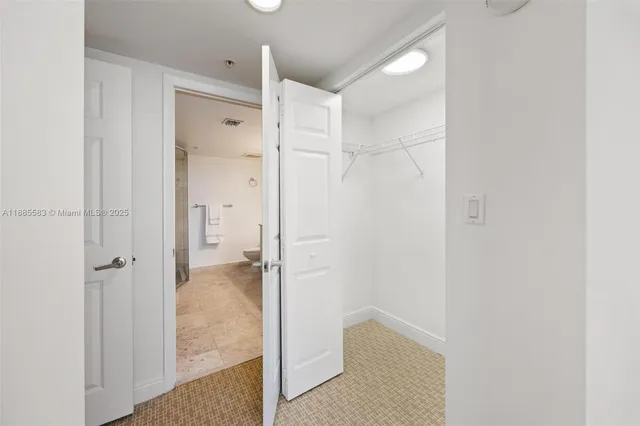 a bedroom with a bed and a potted plant