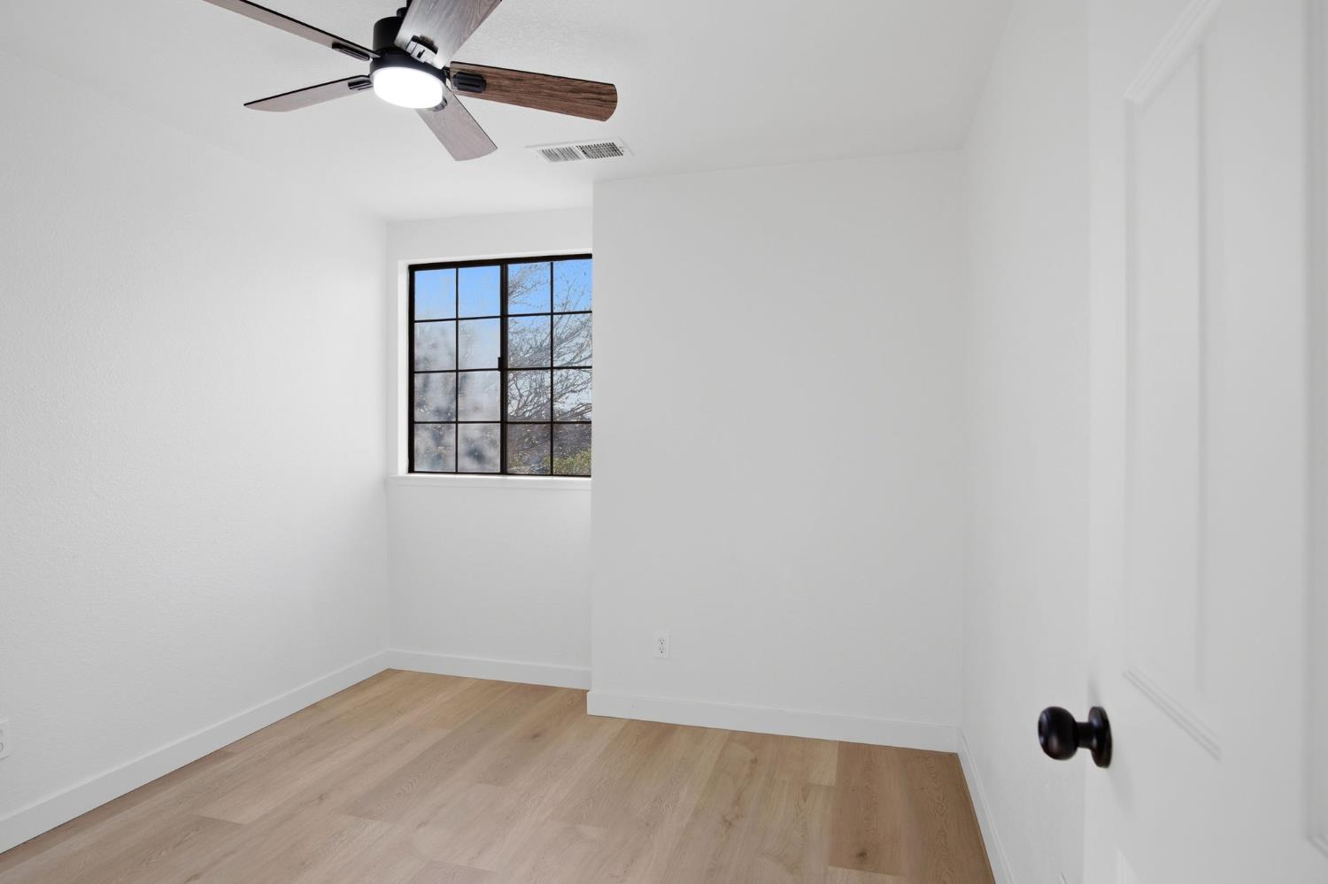 1732 Walpole Drive Modesto, CA 95358 - Photo 13 of 21 an empty room with a window and a fan