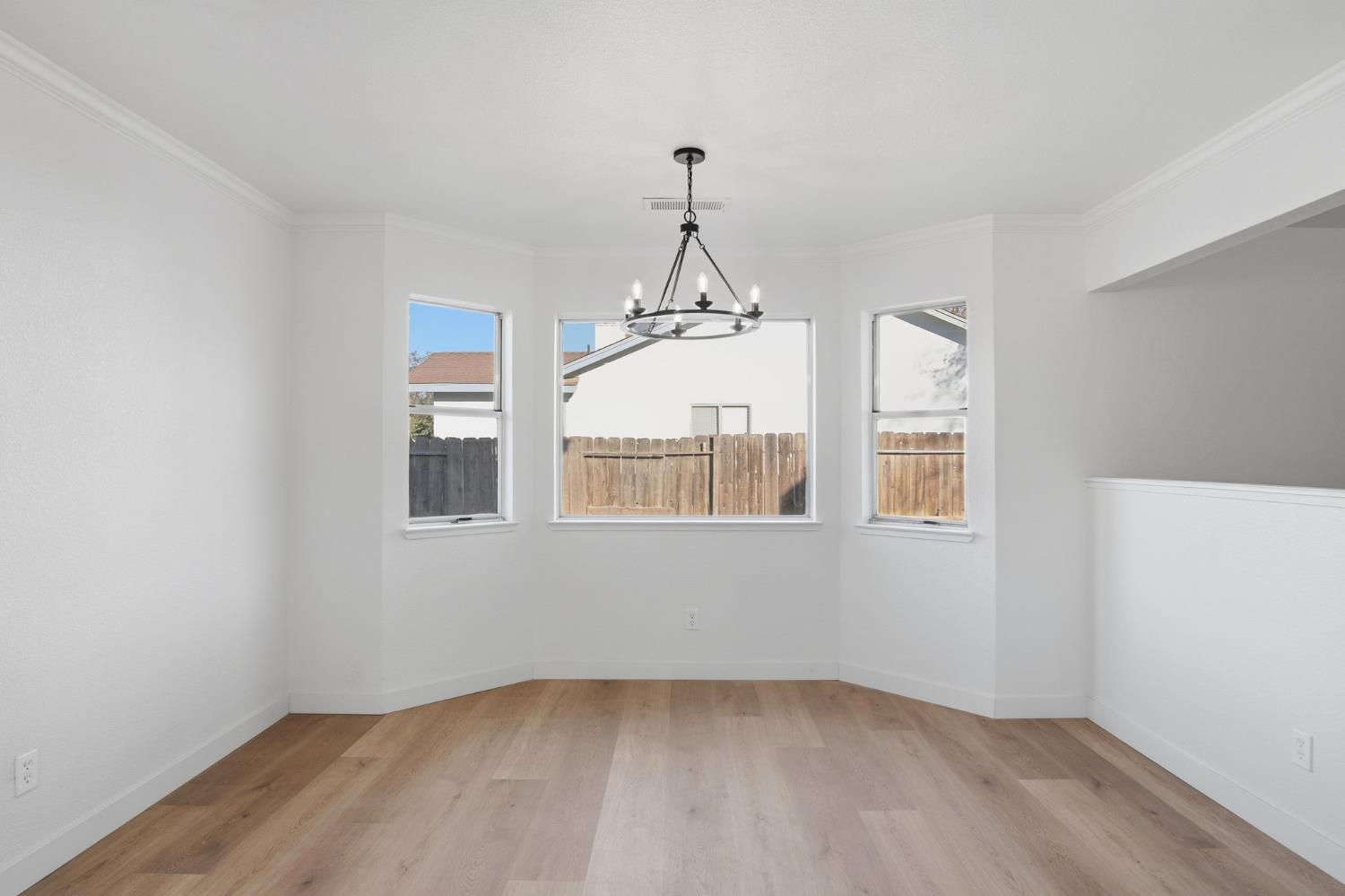 1732 Walpole Drive Modesto, CA 95358 - Photo 9 of 21 wooden floor in an empty room with a window