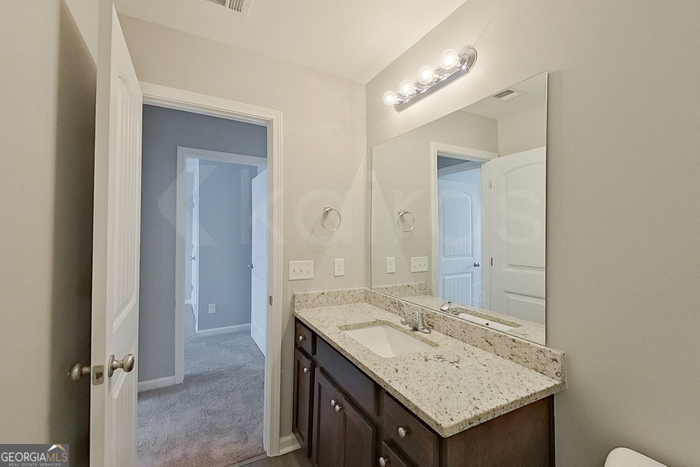 108 Ebenezer Blf Way Springfield, GA 31329 - Photo 17 of 28 a bathroom with a granite countertop sink and a mirror