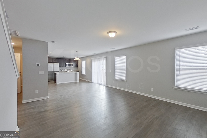 108 Ebenezer Blf Way Springfield, GA 31329 - Photo 2 of 28 a view of empty room with wooden floor