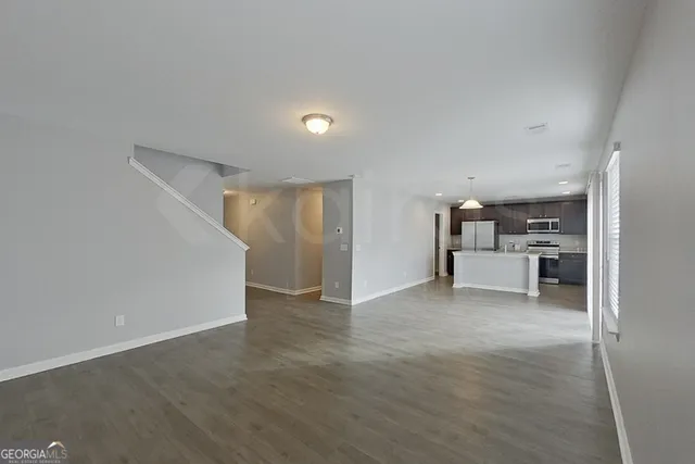 a view of a kitchen with a sink and cabinets