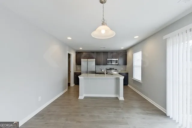 a view of a kitchen with a sink and microwave