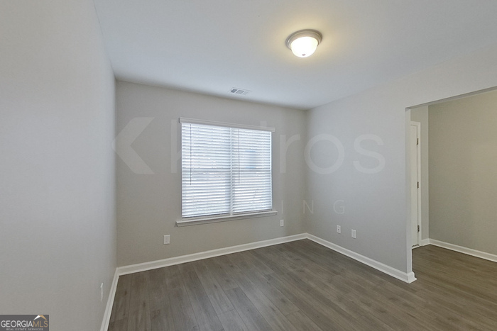 108 Ebenezer Blf Way Springfield, GA 31329 - Photo 7 of 28 an empty room with wooden floor and windows