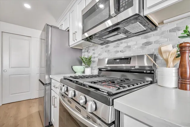 a stove top oven sitting inside of a kitchen
