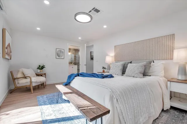 a bedroom with a bed and a couch