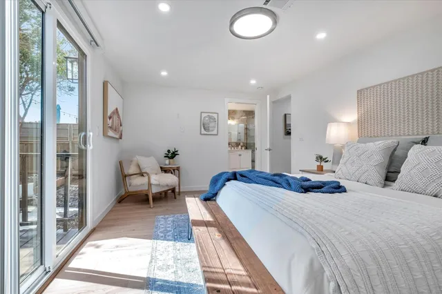 a spacious bedroom with a bed and a large window