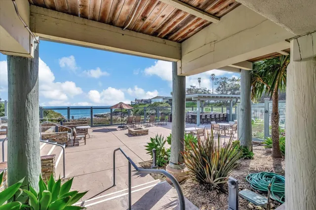 a view of swimming pool with lawn chairs